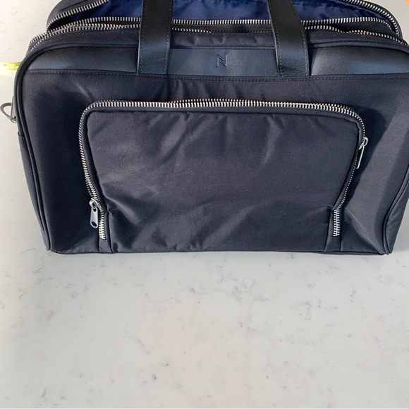 Black Travel Bag with Structured Design and Metal Feet - Picture 10 of 16